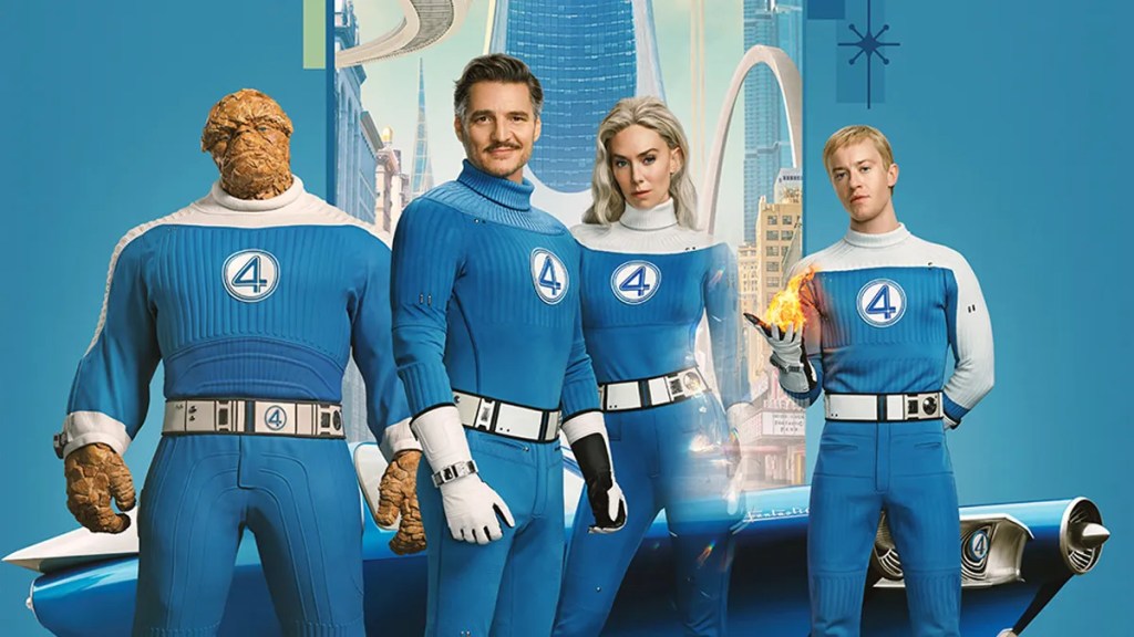 The main cast of Fantastic Four: First Steps (2025) in their iconic blue suits, standing in front of a futuristic city backdrop. From left to right: The Thing, Reed Richards (Pedro Pascal), Sue Storm, and Johnny Storm with his hand ignited in flame.